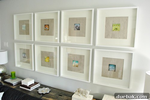 Close-up of small, Polaroid-style art prints with textured fabric background in frames