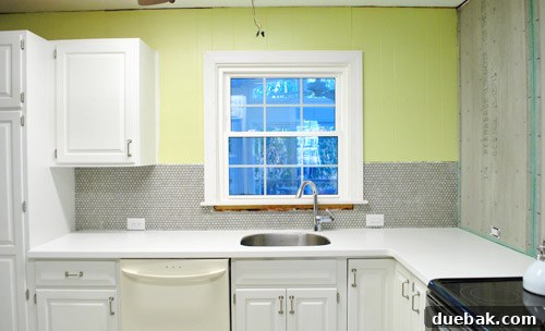 Kitchen backsplash with penny tile, showing window