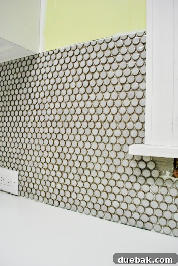 Carefully aligning penny tiles for a seamless look