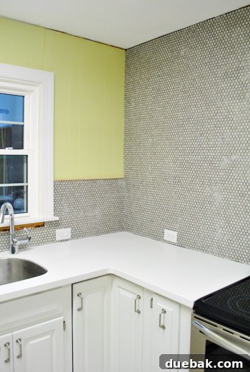 Close-up of how penny tiles meet at an internal corner of the kitchen wall