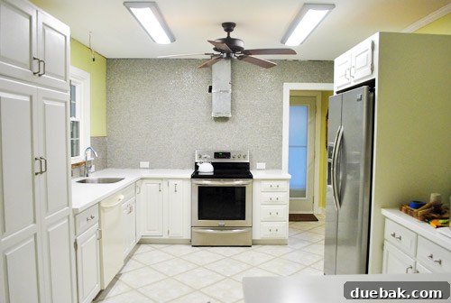 Kitchen backsplash with newly installed penny tiles awaiting grout and other fixtures