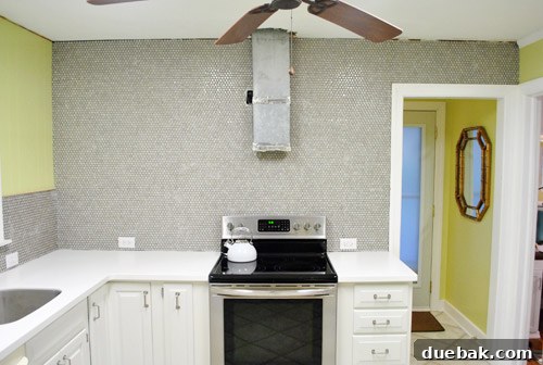 Kitchen wall showing the newly tiled surface meeting the ceiling line