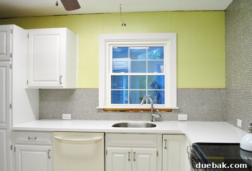 Kitchen wall featuring a window, illustrating the space where floating shelves will be installed
