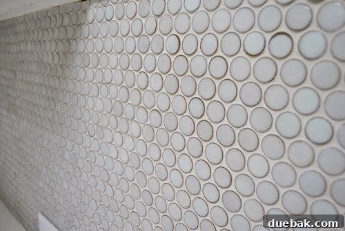 Before and after grouting penny tiles, showing the dramatic transformation.