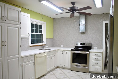 Full view of the room with the newly grouted penny tile installation, showing its overall impact.