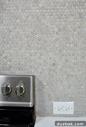 Close-up of ungrouted penny tiles, revealing gaps between each piece.