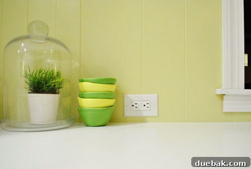 Kitchen counter with a newly installed electrical outlet to the right of the refrigerator