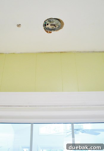Kitchen showing newly installed lighting fixtures and overall renovated space, awaiting crown molding