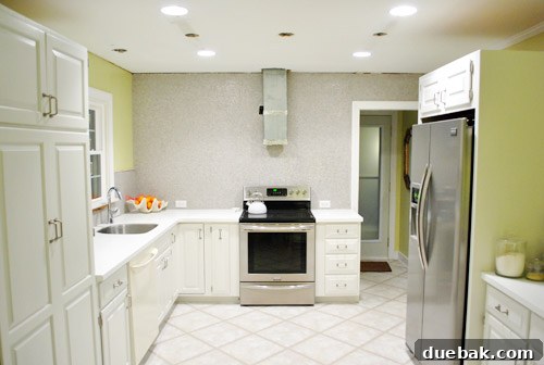 Kitchen ceiling showing multiple holes from removed and new lighting fixtures, highlighting electrical preparation
