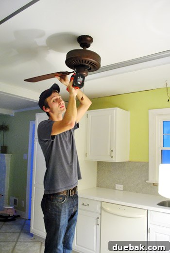 Removed old fan and fluorescent light fixtures, leaving holes in the ceiling