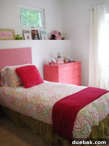 Olivia's room after makeover, featuring the upholstered headboard and new duvet