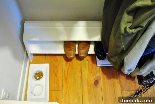 John's side of the closet with ample empty space on the shoe rack.