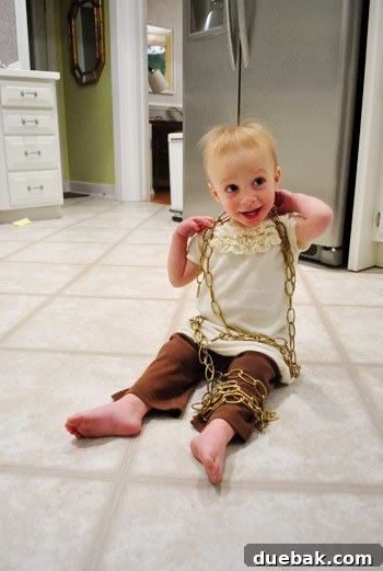 Clara playing with the excess light fixture chain, showcasing a humorous side project.