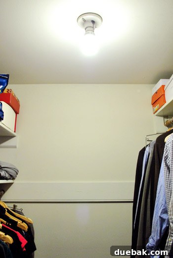 The original bare bulb light fixture in the closet, highlighting the lack of character and dim lighting.