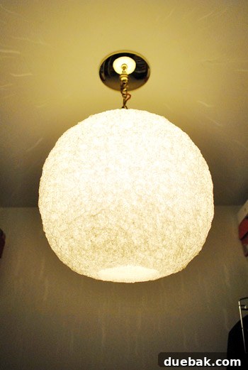 A panoramic view of the closet, showing the new light fixture and the beginnings of other organizational changes.