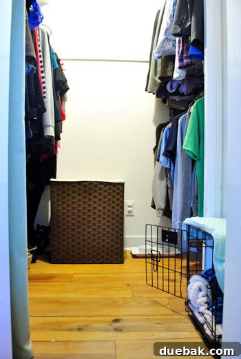 The closet in its disarrayed state, with a laundry basket displaced due to the dog crate.