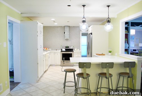 Elevating Kitchen Style with Twin Glass Pendants 2 Close-up of a clear glass globe pendant light hanging above a kitchen counter