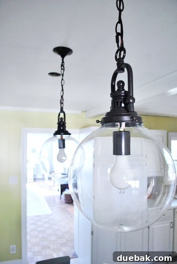 Elevating Kitchen Style with Twin Glass Pendants 11 Detailed shot of the kitchen counter and a single pendant light