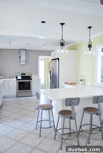 Elevating Kitchen Style with Twin Glass Pendants 13 View of the kitchen from the dining room, showing the openness of the peninsula
