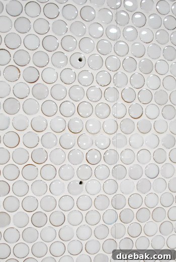 Close-up of drilled holes in kitchen tile