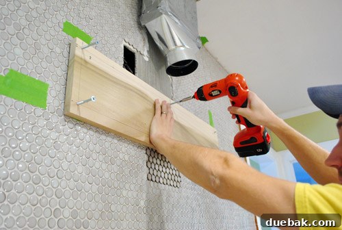 First wood mounting plank securely attached to the wall
