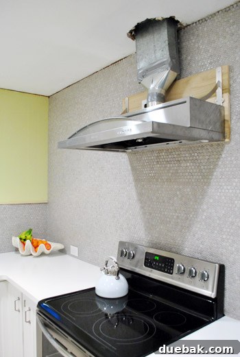 Installed range hood showing exposed wood support from the side