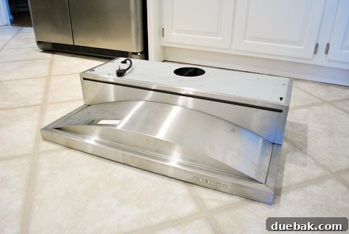 Homeowner looking at the under cabinet range hood