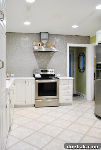 Homeowner proudly standing by the securely installed range hood
