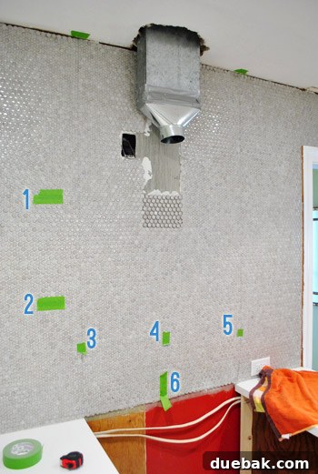 Wall marked with painter's tape for range hood installation