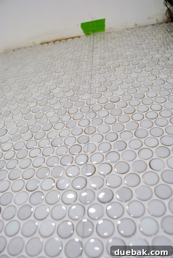 Close-up of string marking stud location on tiled wall