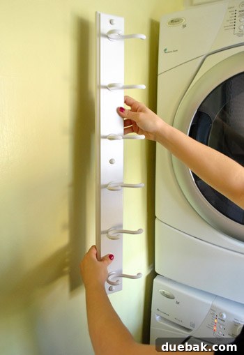 Streamline Your Laundry and Mudroom 3 Newly spray-painted glossy white coat rack, looking fresh and modern.