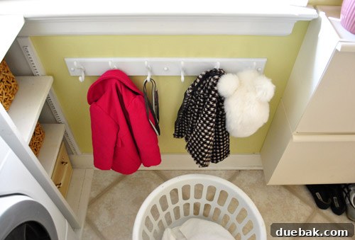 Streamline Your Laundry and Mudroom 9 Overview of the organized laundry room, showcasing shelves, bins, and the coat rack.