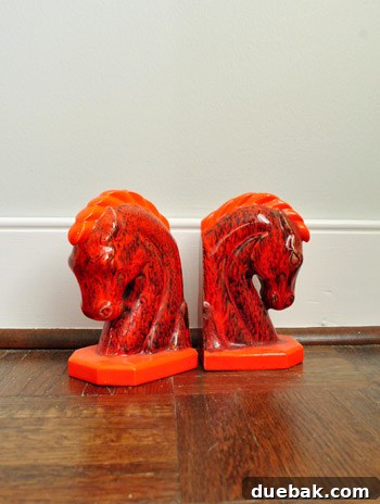 DIY Bookends: A Burst of Color 2 Two thrift store horse head bookends, before their DIY transformation, showing their original orange and black sponge paint finish.