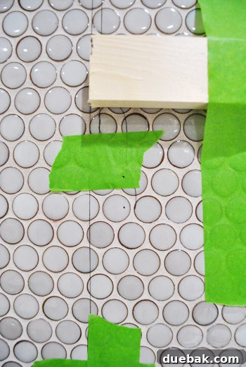 Close-up of screws securely installed into the tiled wall, ready for shelf brackets.