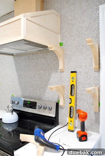 A wooden shelf bracket temporarily hung on the wall, showing how the final shelves will appear.