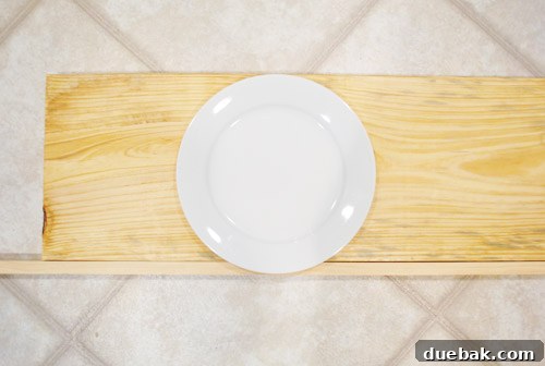 A wooden shelf with a 1x2 trim piece attached to the front edge, demonstrating the solution for plate overhang.