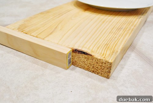 Close-up of a wooden shelf board with its rough end covered by a smooth piece of trim.