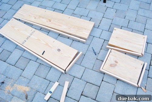 Different wooden shelf boards, some with trim attached on one side, others on two, ready for assembly.