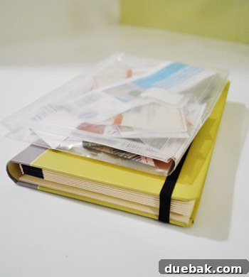 A close-up of the organizer's contents, showing a variety of coupons neatly stored in their respective categorized pockets.