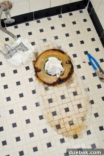Rock-Solid Toilet: Easy DIY Fix 12 Old wax ring around toilet flange after toilet was removed from bathroom floor
