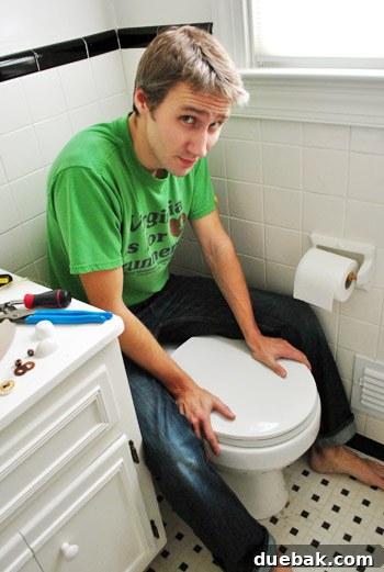Rock-Solid Toilet: Easy DIY Fix 20 John applying pressure to toilet bow to secure wax ring in place