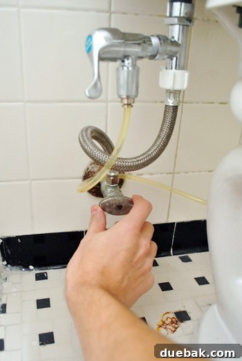 Rock-Solid Toilet: Easy DIY Fix 3 Turning off water valve to toilet with cloth diaper sprayer attachment