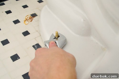 Rock-Solid Toilet: Easy DIY Fix 22 Tightening nut on toilet bowl bolts to fix rocking toilet