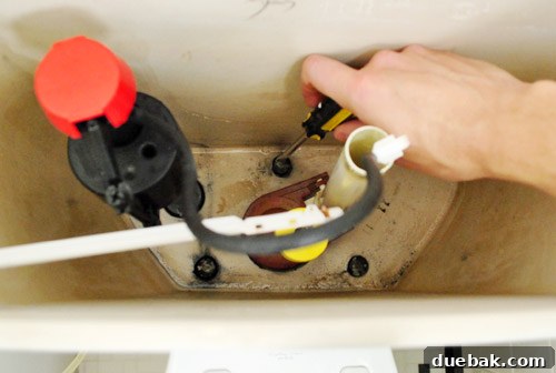 Rock-Solid Toilet: Easy DIY Fix 24 Reinstalling toilet tank by tightening screws within toilet tank