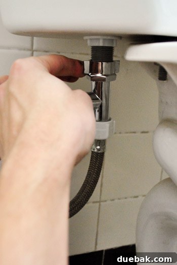 Rock-Solid Toilet: Easy DIY Fix 25 Reattaching water supply line to underside of toilet tank