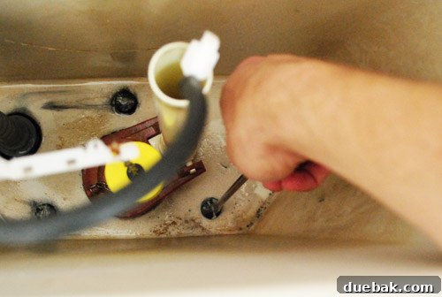Rock-Solid Toilet: Easy DIY Fix 7 Unscrewing toilet tank from the bowl from inside the drained tank