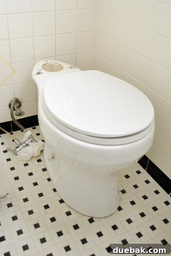 Rock-Solid Toilet: Easy DIY Fix 9 Toilet bowl with tank removed during wax ring repair