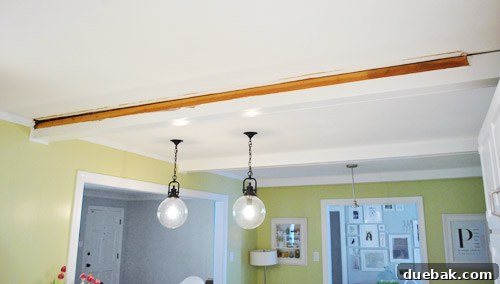 Kitchen in a state of renovation, looking messy during crown molding installation