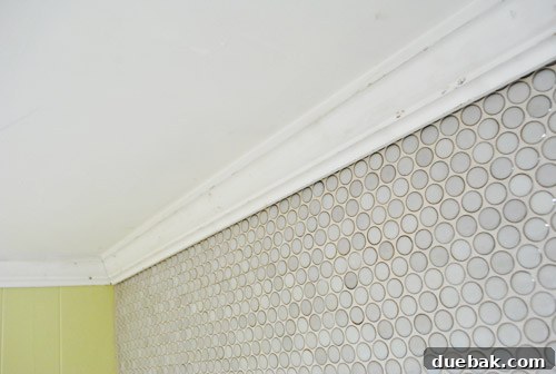 Crown molding showing minor damage and imperfections after installation