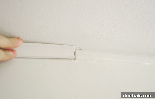 Cove molding installation detail on a kitchen beam